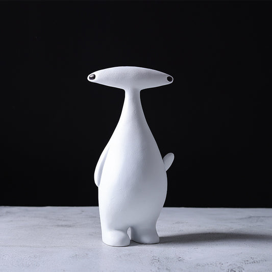 Abstract dog and alien figurines