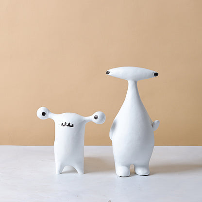 Abstract dog and alien figurines