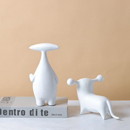 Abstract dog and alien figurines