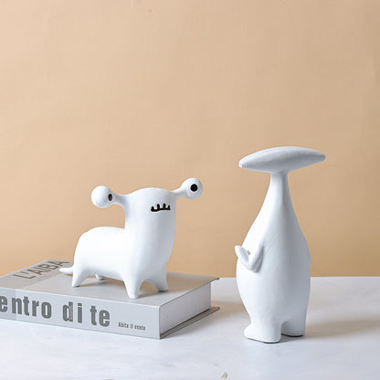 Abstract dog and alien figurines