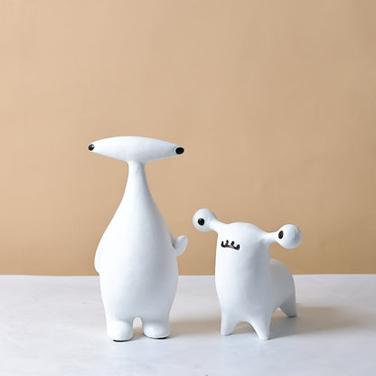 Abstract dog and alien figurines