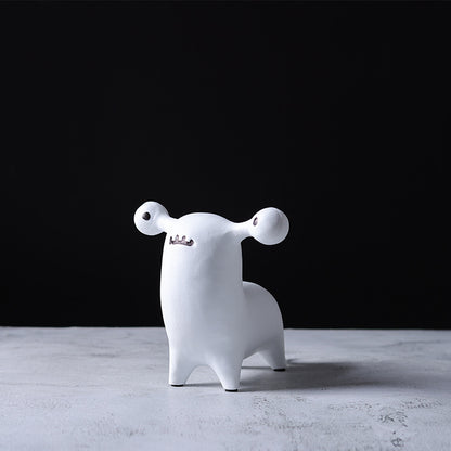 Abstract dog and alien figurines