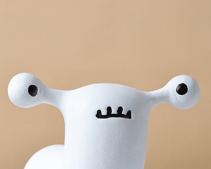 Abstract dog and alien figurines