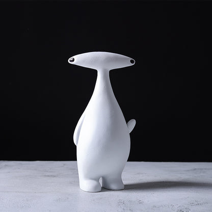 Abstract dog and alien figurines